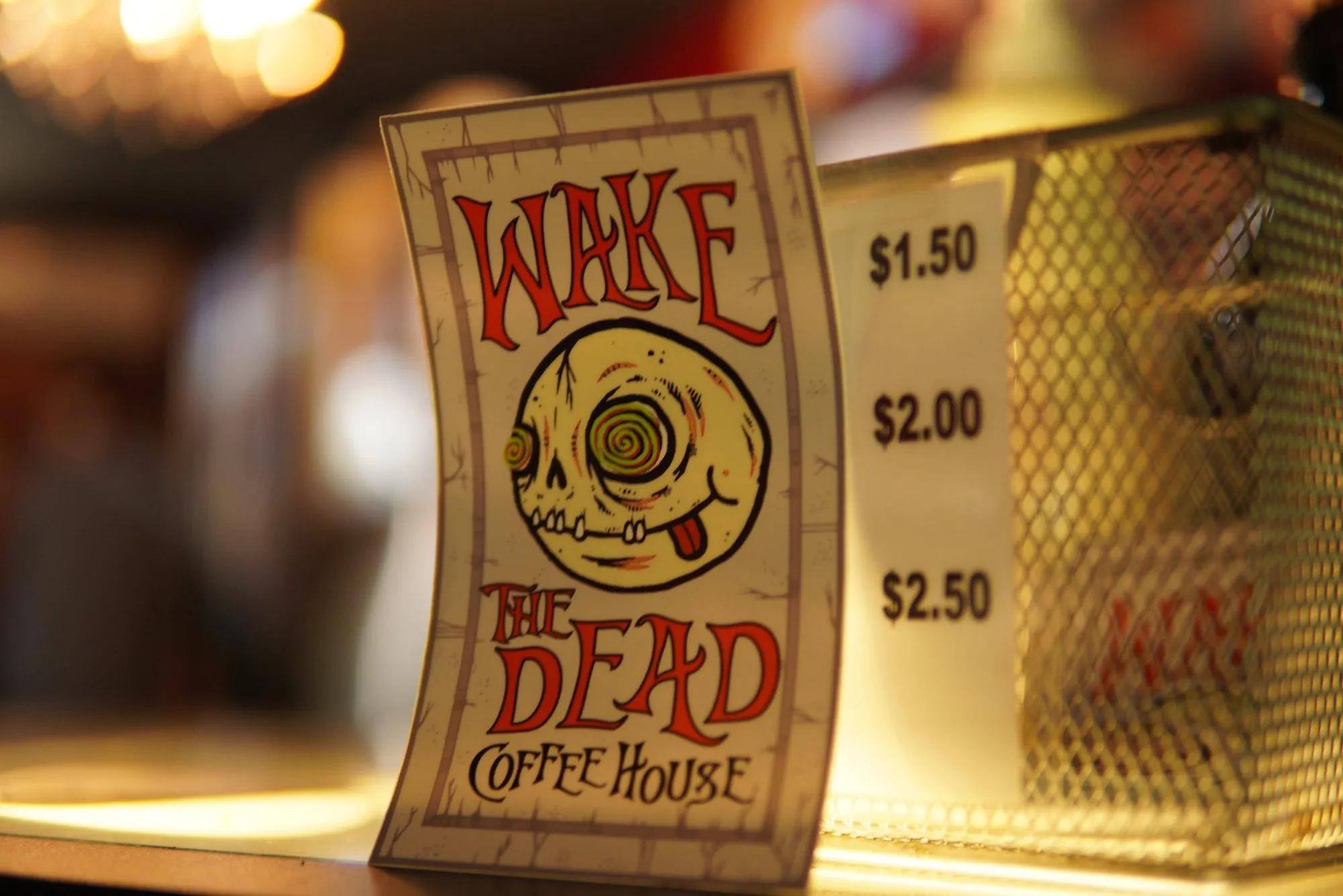 The Wake The Dead skull card standing on the coffee counter